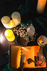 Cozy workspace with to-do list, coffee and candles &ndash; planning and mindfulness concept