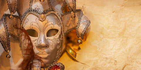 the mask in front of a sheet of old yellowed paper