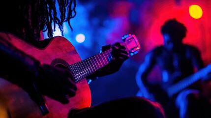A musician playing a guitar on stage.