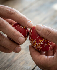 Hands Holding Red Bulgarian Easter Eggs Before Tapping