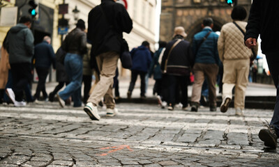 Pedestrians Crossing The Road On A Rubble Stone Road In The Historic Center Of A European City