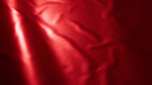 Abstract red fabric texture with soft shadows and fluid forms for backgrounds