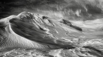 The winds unseen force can be felt in the everchanging landscape of sand dunes leaving behind a trail of mesmerizing patterns. Black and white art