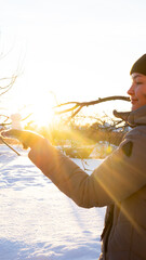 woman holds a duck-shaped figure made of snow in her hand, conspiracy games, cold season
