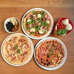 Three nice  pizza  on white plat on wooden table