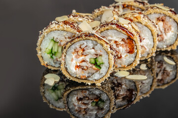 Baked sushi roll with chicken cucumber and almond flakes close up © Надія Коваль