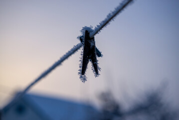 Clothespin and rope covered with frost