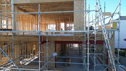 Wooden house frame under construction, timber structure residential building site

