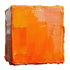 A cube made from bright orange paint is placed on a white surface with no other items nearby in daylight