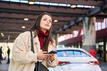 Woman using phone app waiting for ride