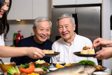 Joyful family gathering with seniors enjoying a delicious asian meal together at home. Family celebrate Chinese New Year