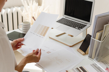 Female Designer Reviewing Color Palette and Branding Materials