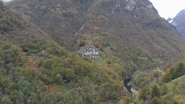 Aerial view of Lavertezzo, a village nestled amidst lush green mountains and a winding river, creating a serene landscape, Verzasca, Ticino, Switzerland.