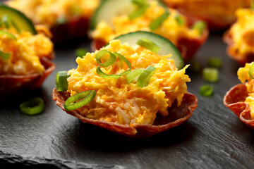 Crispy salami cups with cheese filling, antipasto, snack, party food