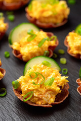 Crispy salami cups with cheese filling, antipasto, snack, party food