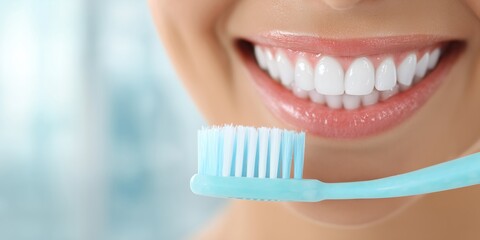 Close-up of a smiling woman showing perfect white teeth and healthy gums, holding a blue toothbrush, concept for dental hygiene advertisement, oral care product packaging and beauty routines