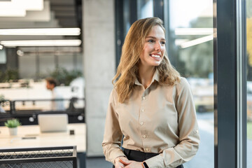 Confident stylish european woman standing at workplace, executive leader manager smiling.