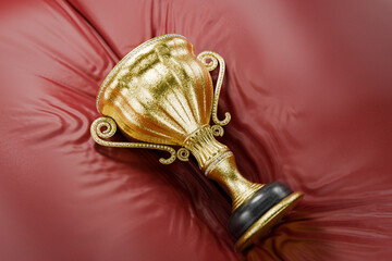 Winners' cup on a red cushion. Prize place. Gold winners' cups as a reward. Achievements. Victory. Goal achievement concept. First place computer game. Award for outstanding achievement. 3D render