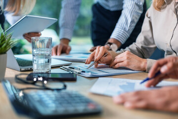 Business person analyzing financial statistics displayed on the tablet screen