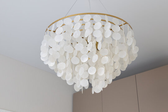 Stylish capiz shell chandelier creating cozy ambient lighting indoors
