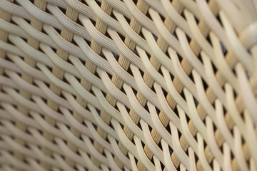 Macro shot of beige woven rattan texture with intricate geometric pattern creating calm and rustic...
