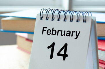 February 14 desk calendar on a clean workspace background
