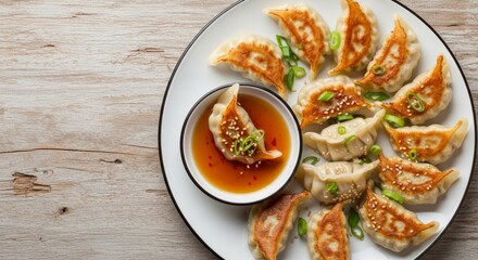 Delicious chinese dumplings with soy sauce and scallions on rustic wooden table