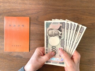 Japanese pension concept with elderly hands and money