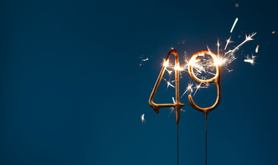 49 years celebration festive background made with Bengal fires in the form of number forty nine.