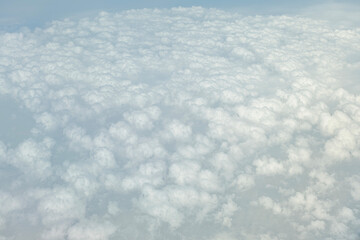 high altitude fluffy white cumulus clouds