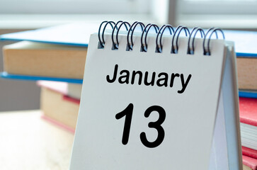 Desk calendar showing January 13 on blur office background