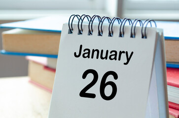 Desk calendar showing January 26 on blur office background