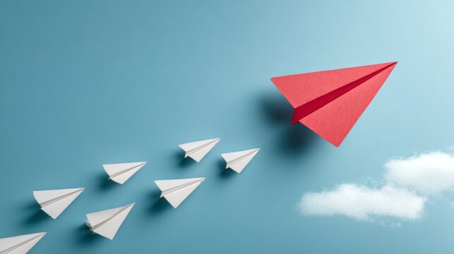 Red Paper Plane Leading White Planes in Blue Sky.