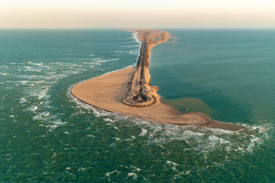 Aerial view of the stark contrast between the tranquil turquoise waters and the sandy strip of land, punctuated by the ruins, Dhanushkodi, Tamil Nadu, India.
