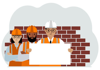 Construction team holding a white sheet of paper for text. Brickwork next to him.