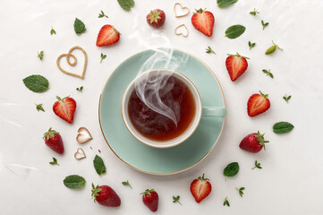 a cup of tea with strawberries and berries around the center