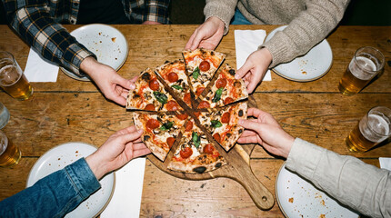 Top view of friends sharing pizza and beer