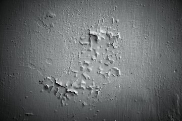 Close up of peeling white paint texture on an old weathered wall.