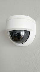 Modern security surveillance camera mounted on wall for home and business safety