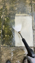 Pressure washing transformation of mossy pavers for clean outdoor space maintenance
