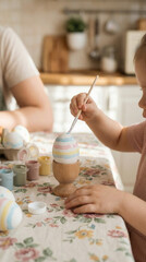 Child painting colorful easter egg at home for holiday celebration and family crafting activities