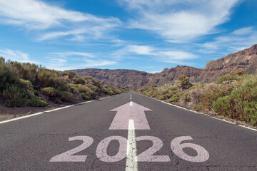 Wide open road under a blue cloudy sky with 2026 on road surface