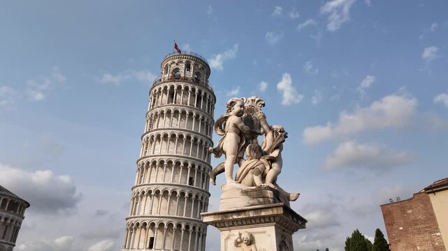 Leaning Tower of Pisa and historic statue with parallax effect in Tuscany, Italy - Sideways stabilized tracking shot