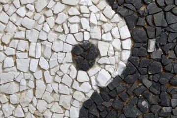 Yin and Yang Mosaic: A close-up view of a Yin and Yang symbol, beautifully rendered in a mosaic of black and white stones.