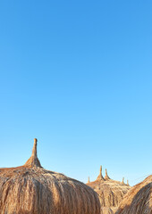 Straw umbrellas on the beach in Hurghada, selective focus, Egypt.