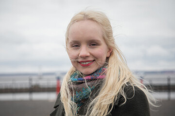 Outdoor portrait of a young woman with blond hair