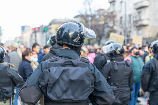Riot police in winter city street protest, crowd control and public demonstration security