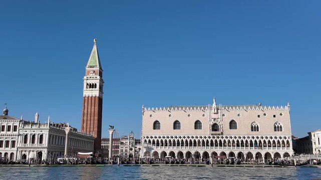 Doge's Palace and St Mark's Campanile from water at sunset in Venice, Italy - Low angle view, Cinematic stabilized shot