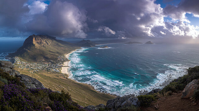 A panoramic vista of a coastal city nestled between a towering mountain and a vibrant ocean under a dramatic, cloud-filled sky.
