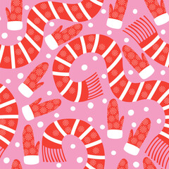 Vector seamless pattern with red mittens and scarves in snowflake pattern on a pink background © Maryna_R